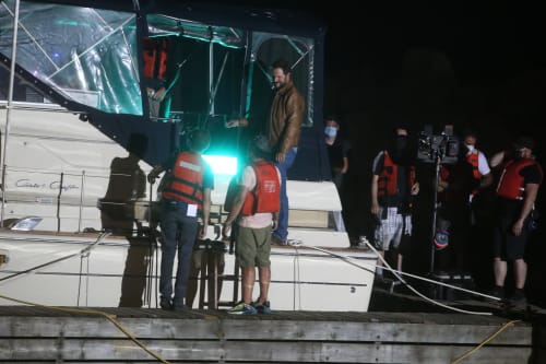 Cast and crew film a night scene on a boat at the St. Catharines Marina.